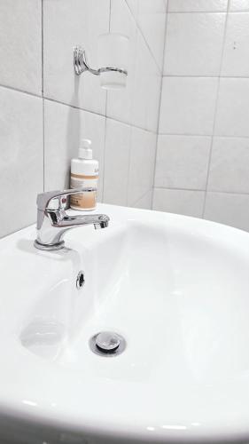 a white bathroom sink with a faucet on it at HMT Exquisite Spaces in Polokwane