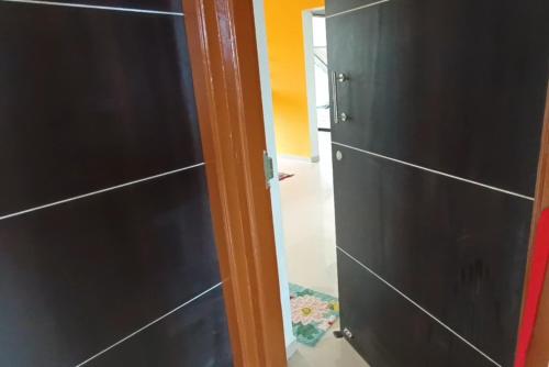a closet with black cabinets and a door at Spacious & Deluxe Vacation Apartment In Tarkarli in Malvan