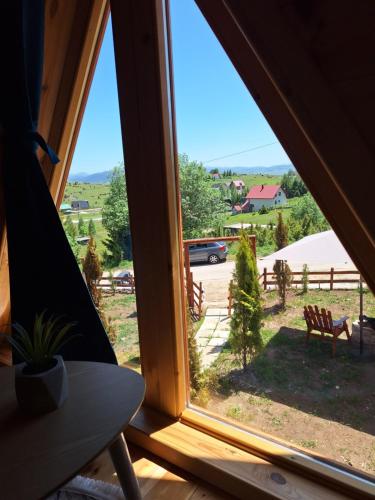 a window view of a yard from a tent at Chalets Montenegrina in Žabljak