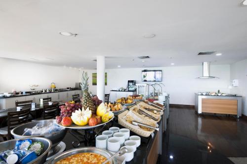 a buffet line with many different types of food at Comfort Suites Macaé in Macaé