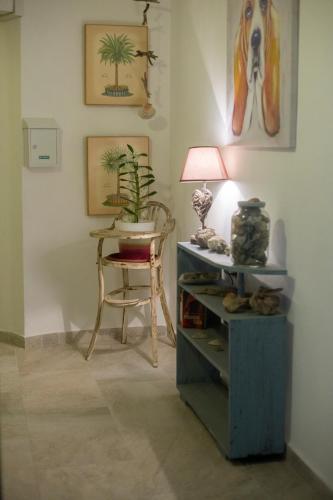 a room with a table and a lamp and a chair at Apartamentos Calypso in Punta Umbría