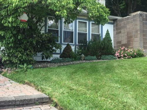 a house with a yard with green grass at Top of the Hill, Meadowbrook in Syracuse
