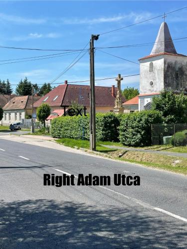 an empty street in a small town with a church at Stupa-Rezi-Tatika-Haz in Zalaszántó
