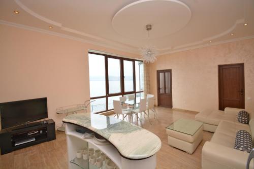 a living room with a couch and a tv at Blue Panorama Sevan in Sevan