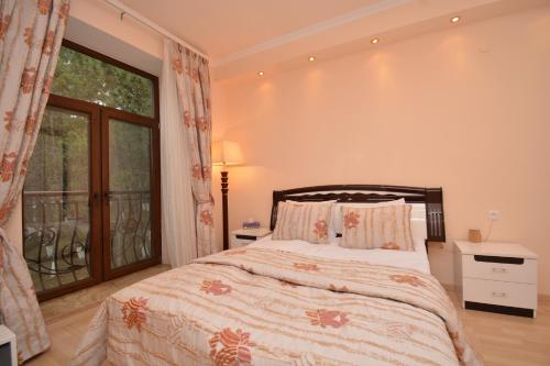 a bedroom with a bed and a large window at Blue Panorama Sevan in Sevan