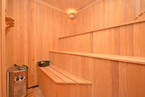a room with wooden walls and shelves in a sauna at Blue Panorama Sevan in Sevan