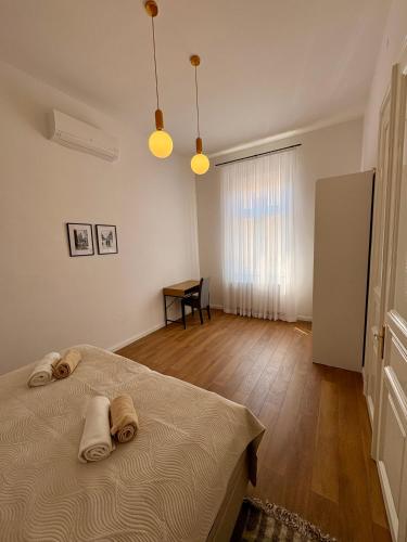 a bedroom with a bed with two towels on it at La Perla Centre in Zagreb