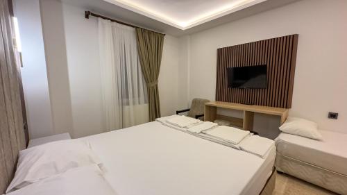 a hotel room with a bed and a television at Casablanca Garden Hotel in Nevsehir