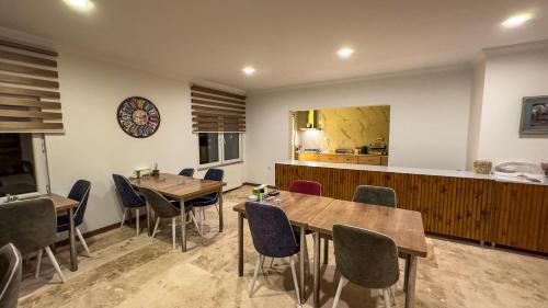 a restaurant with two tables and chairs and a kitchen at Casablanca Garden Hotel in Nevsehir