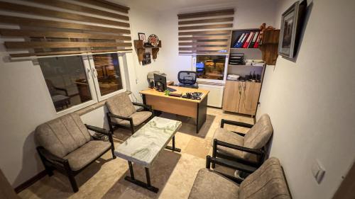 a living room with chairs and a table and a desk at Casablanca Garden Hotel in Nevsehir