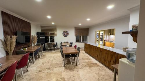 a dining room with wooden tables and chairs at Casablanca Garden Hotel in Nevsehir