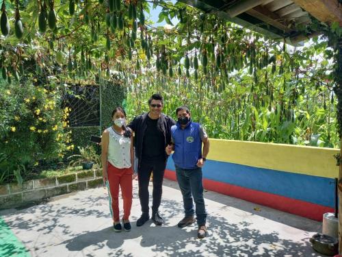 a group of three people posing for a picture at Green House Araque Inn in Otavalo