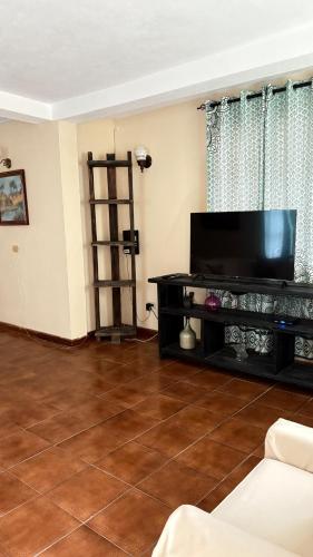a living room with a large flat screen tv at Valley View in Saint George
