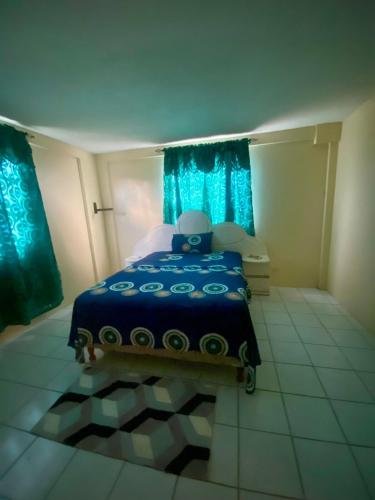 a bedroom with a blue bed with blue curtains at Valley View in Saint George