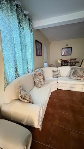 a living room with a white couch and blue curtains at Valley View in Saint George