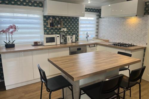 une cuisine avec une table et des chaises en bois dans l'établissement Charming mobile home with pool in Hyères, à Hyères