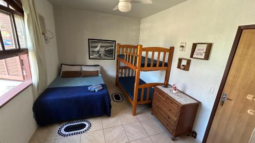 a bedroom with a bed and a bunk bed at Pousada Aconchego de Maricá in Maricá