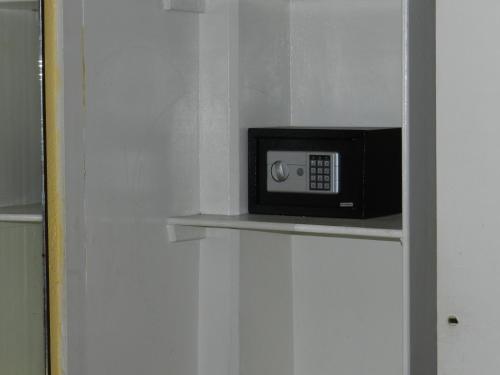 a microwave sitting on a shelf in a room at Hotel San Miguel in Puebla