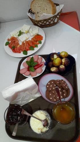 a tray of food on a table with plates of food at Belvedere Apartment in Vlorë