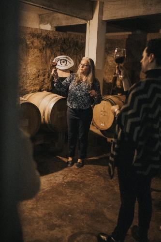 a woman is standing in a wine cellar at Bajo Estrellas Hotel Contemporáneo in Valle de Guadalupe