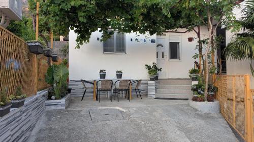 a table and chairs in front of a house at Private guest-house Gutic in Sutomore