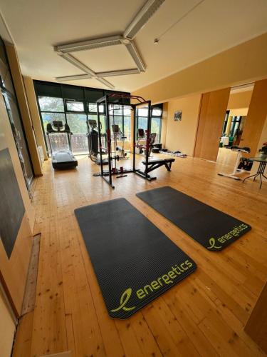 a gym with a black yoga mat on a wooden floor at Das Alpl Resort in Krieglach
