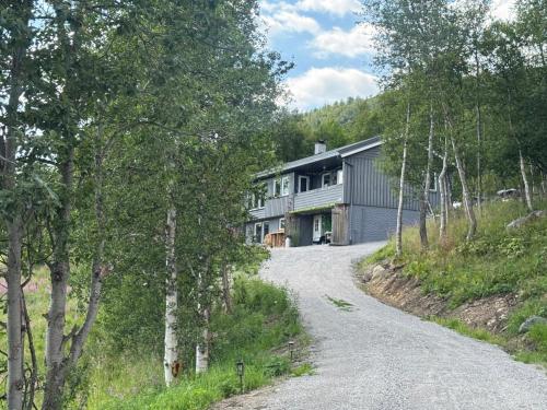 a house on a hill with a gravel road at Bjørkli Lodge in Geilo