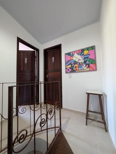 a room with a staircase and a painting on the wall at Casa Jardim 2 in Miguel Pereira