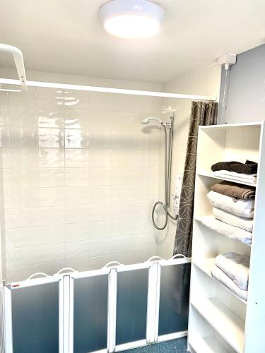 a bathroom with a shower and some towels at 2 bed house sleeps 4-5 in Liverpool