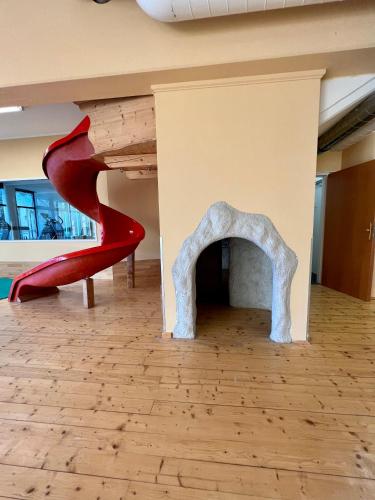 two red shoes in a room with a fireplace at Das Alpl Resort in Krieglach