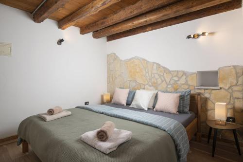 a bedroom with two beds with towels on them at Apartments Casa Antico in Premantura