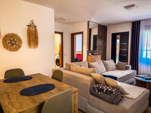 a living room with a couch and a table at TaNa's Villa in Donji Štoj