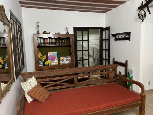 a wooden bench sitting in a room at Casa Jardim 2 in Miguel Pereira