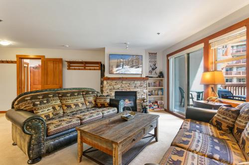 a living room with a couch and a fireplace at 3220 - Two Bedroom Standard Powderhorn Lodge condo in Solitude