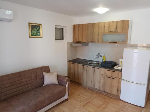 a living room with a couch and a kitchen at Walk to the Sea-1 bedroom BUDVA in Budva