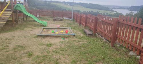 a playground with a play set and a slide at Wiatrak in Ręboszewo