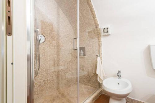 a bathroom with a shower with a toilet and a sink at Nel cuore di Narni in Narni