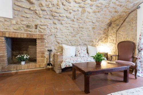 a living room with a couch and a fireplace at Nel cuore di Narni in Narni