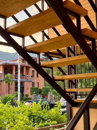 a view from the balcony of a building with a wooden roof at Four Rooms in Lagodekhi