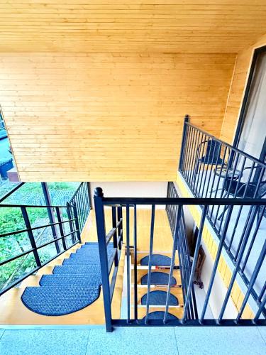 a staircase in a house with a blue carpet at Four Rooms in Lagodekhi