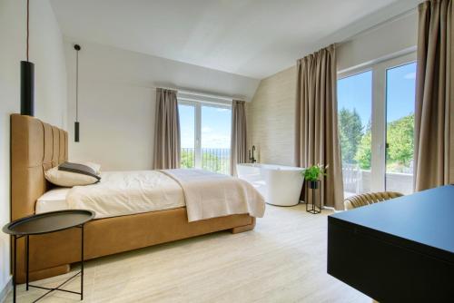 a bedroom with a bed and a bath tub and a sink at Villa One in Jastrebarsko
