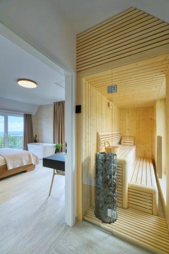 a room with a tub with a bed and a desk at Villa One in Jastrebarsko
