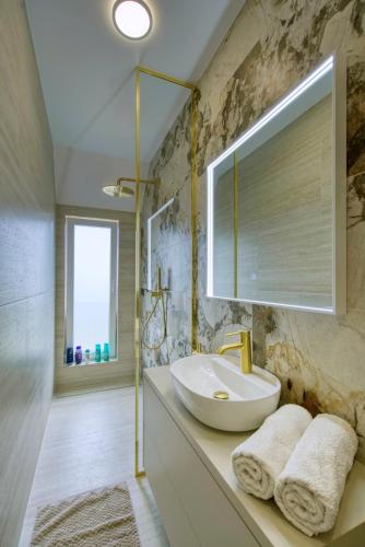 a bathroom with a sink and a mirror at Villa One in Jastrebarsko