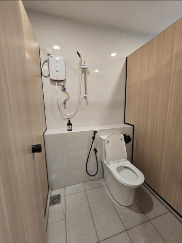 a bathroom with a toilet and a shower at The Backpackers Hut Chow Kit in Kuala Lumpur