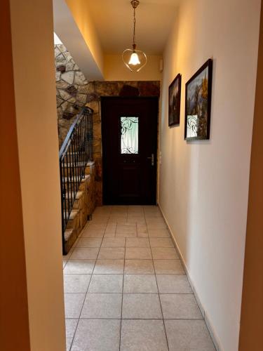 a hallway with a black door and a tile floor at Villa Gaia Navarino in Korifásion