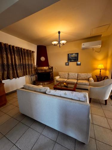 a living room with couches and a couch at Villa Gaia Navarino in Korifásion