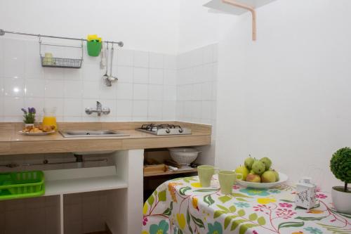 a kitchen with a table with a bowl of fruit on it at Apartamentos Calypso in Punta Umbría