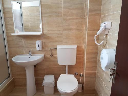 a small bathroom with a toilet and a sink at Hotel New in Baia Mare