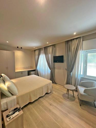 a bedroom with a bed and a chair and a window at Cloud Nine in Riomaggiore