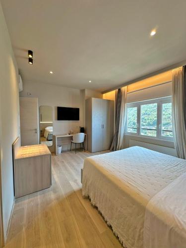 a bedroom with a large bed and a desk at Cloud Nine in Riomaggiore